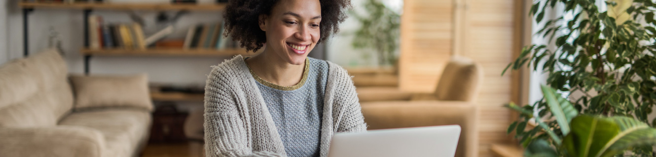 woman looking at her laptop in her living room